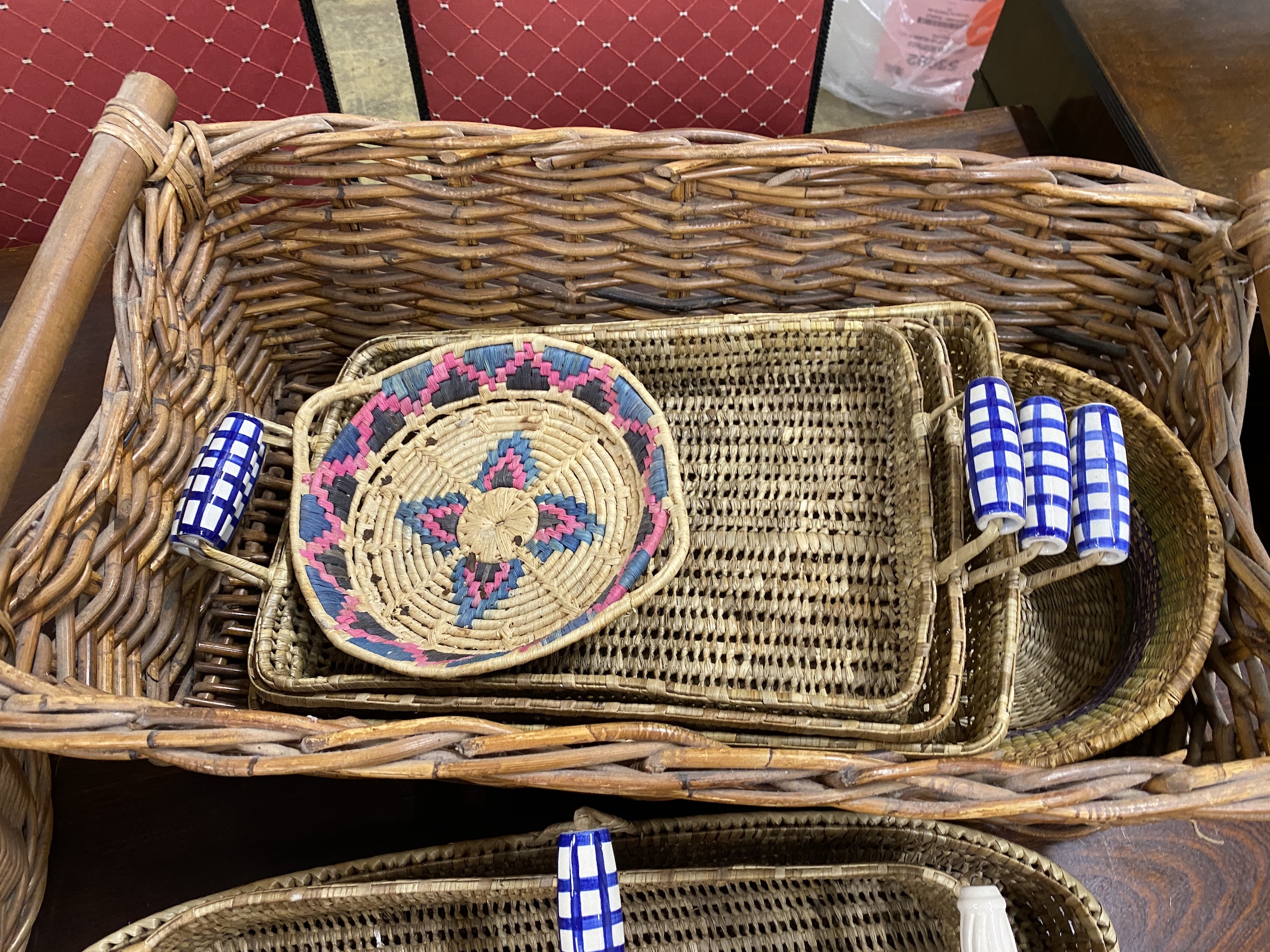 Ten assorted wicker baskets and trays, largest width 67cm, height 25cm